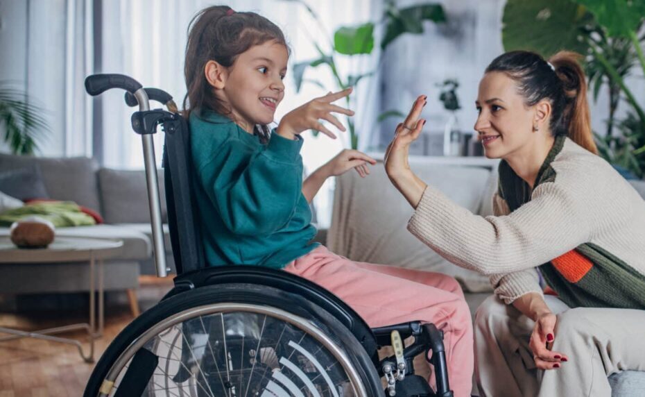 A tender moment of joy as a mother play with her daughter, who is in a wheelchair, filling their living room with laughter.
